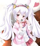  1girl akura_scarlet0495 animal_ears azur_lane bangs brown_eyes bunny_ears candy chocolate chocolate_heart commentary_request covering_mouth eyebrows_visible_through_hair eyes_visible_through_hair fake_animal_ears food hairband head_tilt heart highres holding jacket laffey_(azur_lane) long_hair long_sleeves looking_at_viewer pleated_skirt red_skirt sidelocks skirt solo thighhighs translation_request twintails white_hair zettai_ryouiki 
