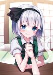  1girl arm_wrestling black_hairband black_ribbon blue_eyes commentary_request fisheye green_vest grey_hair hair_ribbon hairband highres indoors konpaku_youmu konpaku_youmu_(ghost) looking_at_viewer pov ribbon ringed_eyes shirt short_hair short_sleeves smile suzuno_naru touhou vest white_shirt 