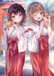  2girls ;d blue_eyes blurry blurry_background brown_hair commentary_request day depth_of_field ema grin hakama hakama_skirt hands_up holding japanese_clothes kimono long_sleeves looking_at_viewer miko multiple_girls nemuri_nemu omikuji one_eye_closed original outdoors red_eyes red_hakama ribbon-trimmed_sleeves ribbon_trim skirt smile torii v white_kimono wide_sleeves 