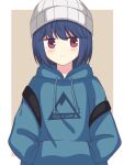  1girl bangs beanie beige_background blue_hair blue_hoodie blush border closed_mouth clothes_writing commentary copyright_name expressionless eyebrows_visible_through_hair hands_in_pockets hat highres hood hood_down hoodie jitome looking_at_viewer medium_hair outside_border print_hoodie purple_eyes shima_rin simple_background solo upper_body white_border white_headwear yurucamp zeta_(24904340) 