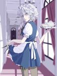  1girl apron blue_dress blue_eyes blurry blurry_background blush braid brown_legwear chandelier closed_mouth cup day door dress dress_lift from_behind green_ribbon grey_hair highres holding holding_knife holding_tray indoors izayoi_sakuya knife knives_between_fingers light_frown lips looking_at_viewer looking_back maid maid_apron maid_headdress nanasuou puffy_short_sleeves puffy_sleeves ribbon shiny shiny_hair shirt short_dress short_hair short_sleeves silver_hair sunlight teacup teapot touhou tray twin_braids vanishing_point white_shirt window 
