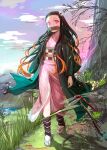  1girl bit_gag black_hair commentary_request full_body gag grass hair_ribbon highres japanese_clothes kamado_nezuko kimetsu_no_yaiba kimono long_hair mikazuki_akira! mountain nature orange_hair pink_eyes pink_kimono print_kimono ribbon sandals solo standing tabi very_long_hair white_ribbon 