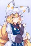  1girl animal_ears arm_under_breasts blonde_hair blush breasts dress eyebrows_behind_hair fox_ears fox_tail hand_on_own_cheek hand_on_own_face hat highres large_breasts light_blue_background multiple_tails pillow_hat short_hair simple_background smile solo tabard tail toluda touhou upper_body white_dress yakumo_ran yellow_eyes 