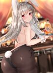  1girl animal_ears ass back backless_leotard bare_arms bare_shoulders bent_over black_leotard blurry breasts brown_legwear bunny_ears bunny_tail closed_mouth cowboy_shot depth_of_field grey_hair highres holding katsushika_pachi leotard long_hair looking_at_viewer looking_back medium_breasts original pantyhose playboy_bunny red_eyes solo standing tail thighband_pantyhose tray wrist_cuffs 