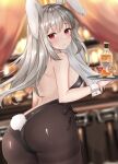  1girl animal_ears ass back backless_leotard bare_arms bare_shoulders bent_over black_leotard blurry breasts brown_legwear bunny_ears bunny_tail closed_mouth cowboy_shot depth_of_field grey_hair holding katsushika_pachi leotard long_hair looking_at_viewer looking_back medium_breasts original pantyhose playboy_bunny red_eyes solo standing tail thighband_pantyhose tray wrist_cuffs 
