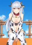  1girl animal_ears animal_print azur_lane bangs bare_shoulders bell bikini blue_sky blush braid breasts butterfly_hair_ornament cleavage closed_mouth cloud collar collarbone commentary_request cow_ears cow_horns cow_print cowboy_shot crown_braid day detached_sleeves dunkerque_(azur_lane) eyebrows_visible_through_hair fake_animal_ears fake_horns fence grey_hair hair_between_eyes hair_ornament highres horns large_breasts leaning_forward long_hair looking_at_viewer multi-strapped_bikini navel neck_bell ponytail red_collar red_eyes rei_(09991) side-tie_bikini sidelocks sitting skindentation sky sleeves_past_wrists solo stomach swimsuit thighhighs white_bikini white_legwear white_sleeves wooden_fence 
