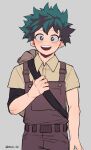  1boy :d absurdres arm_at_side bangs belt blue_eyes boku_no_hero_academia brown_shirt collared_shirt commentary_request cowboy_shot freckles green_eyes green_hair grey_background hand_up highres looking_at_viewer male_focus messy_hair midoriya_izuku modo_(modo_s2) open_mouth overalls pants scar_on_hand shirt short_hair short_sleeves simple_background smile solo twitter_username upper_teeth 
