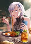  1girl absurdres blue_eyes blueriest blush chopsticks earrings english_commentary eyebrows_visible_through_hair eyewear_removed food food_request glasses green_nails highres holding holding_chopsticks holding_phone hololive hololive_indonesia jewelry nail_polish noodles pavolia_reine phone silver_hair sitting virtual_youtuber 