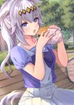  1girl absurdres animal_ears bench blue_eyes blush burger collarbone eyebrows_visible_through_hair food hair_between_eyes highres holding holding_food horse_ears horse_girl horse_tail lilith_degree long_hair oguri_cap_(umamusume) open_mouth pleated_skirt school_uniform short_sleeves silver_hair sitting skirt solo tail tracen_school_uniform umamusume white_skirt 