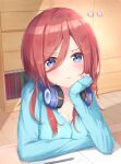  1girl blue_cardigan blue_eyes blush book breasts brown_hair cardigan cleavage drawer go-toubun_no_hanayome head_rest headphones headphones_around_neck highres indoors long_hair nakano_miku paper pen pout shiora_draw_draw shirt sitting sleeves_past_wrists solo table wardrobe white_shirt 