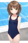  1girl anz32 arms_behind_back bangs bare_arms bare_shoulders blue_swimsuit blurry blurry_background blush breasts brown_hair closed_mouth collarbone commentary covered_navel cowboy_shot depth_of_field eyebrows_visible_through_hair green_eyes new_school_swimsuit one-piece_swimsuit original school_swimsuit small_breasts solo swimsuit twitter_username two_side_up 