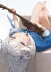  1girl barefoot blue_eyes blue_jacket commentary fish_tail gawr_gura hair_ornament highres holding holding_instrument hololive hololive_english instrument jacket legs long_hair looking_at_viewer lying mossi on_back shark_tail sharp_teeth smile solo tail teeth toenails toes ukulele virtual_youtuber white_hair 