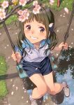  1girl adidas black_hair blurry blurry_foreground blush brown_eyes cherry_blossoms day grin gym_uniform highres looking_at_viewer original outdoors pairan puddle short_shorts shorts smile solo swing tears twintails 