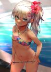  1girl aqua_eyes bangs bikini bikini_bottom_pull bikini_pull bikini_tan blurry blurry_background blush bow clothes_pull commentary_request depth_of_field flat_chest flower grecale_(kancolle) grin groin hair_between_eyes hair_bow hair_flower hair_ornament hibiscus highres jewelry kantai_collection long_hair looking_at_viewer multicolored multicolored_bikini multicolored_clothes nail_polish navel necklace pink_bow platinum_blonde_hair ponytail pool pulled_by_self pussy pussy_peek rampage_2nd red_flower side_ponytail sidelocks smile smug solo sparkle stomach swimsuit tan tanlines water wet 