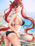  1girl ass azur_lane bangs beach bikini blurry blurry_background blush breasts eyewear_on_head floating_hair from_side gigamessy hair_ribbon halterneck hand_on_railing honolulu_(azur_lane) honolulu_(summer_accident?!)_(azur_lane) large_breasts long_hair looking_at_viewer medium_breasts ocean open_mouth red_eyes red_hair ribbon strap_gap sunglasses swimsuit twintails very_long_hair 