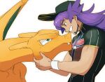  1boy baseball_cap champion_uniform charizard dark-skinned_male dark_skin eye_contact facial_hair fang fang_out gen_1_pokemon green_eyes grin hat holding holding_pokemon leon_(pokemon) long_hair looking_at_another male_focus morio_(poke_orio) pokemon pokemon_(creature) pokemon_(game) pokemon_swsh purple_hair shield_print shirt short_sleeves smile sword_print symbol-only_commentary teeth white_background white_wristband wristband yellow_eyes 