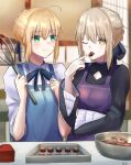  2girls ahoge apron artoria_pendragon_(fate) bangs blonde_hair braid chocolate cooking dress eating eyebrows_behind_hair eyebrows_visible_through_hair fate/grand_order fate/stay_night fate_(series) food green_eyes hair_between_eyes hair_ribbon highres holding holding_chocolate holding_food holding_whisk indoors looking_at_viewer multiple_girls one_eye_closed ribbon saber saber_alter shirt sii_artatm table upper_body whisk yellow_eyes 