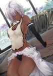  1girl absurdres bangs bare_shoulders blue_eyes breasts carpet chiwa_kotarou cleavage couch dark-skinned_female dark_skin detached_sleeves dutch_angle flower frills highres looking_at_viewer original short_hair silver_hair sitting sleeves_past_wrists solo table 