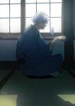  1boy backlighting barefoot blue_kimono closed_mouth commentary_request cup from_side gintama highres holding holding_cup indoors japanese_clothes kimono long_sleeves looking_away male_focus profile sakata_gintoki sakazuki signature sitting soles solo tokkuri uraki_(tetsu420) white_hair wide_sleeves window 