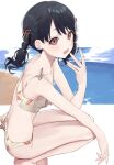  1girl :d bangs bare_arms bare_legs bare_shoulders barefoot beach bikini black_hair blush bow breasts brown_eyes commentary day eyebrows_visible_through_hair fangs floral_print from_side fukumaru_koito hair_ornament highres horizon idolmaster idolmaster_shiny_colors looking_at_viewer looking_to_the_side ocean open_mouth print_bikini purple_eyes ribbon sand smile solo spread_legs squatting swimsuit syhan twintails water white_bikini 
