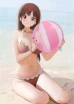  1girl absurdres ball bare_legs bare_shoulders barefoot beach beachball bikini breasts brown_bikini brown_eyes brown_hair cleavage closed_mouth commentary_request fingernails food-themed_necklace highres hitodama_(madatohi) holding holding_ball idolmaster idolmaster_shiny_colors large_breasts long_hair looking_at_viewer nail_polish navel ocean outdoors red_nails sitting smile solo sonoda_chiyoko swimsuit thighs yokozuwari 