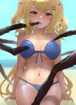  1girl akai_haato arthropod_legs beach bikini blonde_hair blue_bikini blue_eyes breasts chan1moon commentary hair_ornament heart heart_hair_ornament highres hololive long_hair looking_at_viewer medium_breasts mouth_pull open_mouth sitting solo swimsuit virtual_youtuber 