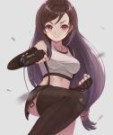  1girl bangs bare_shoulders black_hair black_legwear black_skirt blurry blurry_foreground blush breasts clenched_hands commentary crop_top dangle_earrings earrings elbow_gloves eyebrows fighting_stance final_fantasy final_fantasy_vii final_fantasy_vii_remake fingerless_gloves gloves jewelry knee_up long_hair looking_ahead low-tied_long_hair materia medium_breasts midriff miniskirt purea red_eyes shirt skirt smile solo suspender_skirt suspenders swept_bangs tank_top taut_clothes taut_shirt thighhighs tifa_lockhart v-shaped_eyebrows very_long_hair white_background white_tank_top 