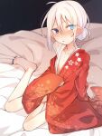  1girl ahoge blue_eyes blue_nails blush floral_print hair_between_eyes hair_bun heterochromia higashi_shino highres japanese_clothes kimono looking_at_viewer nail_polish nowareno_(higashi_shino) on_bed original parted_lips pointy_ears print_kimono red_kimono sitting solo toenail_polish toenails white_hair yokozuwari 