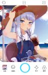  1girl absurdres bag beach bloop_(gawr_gura) blue_dress blue_eyes blush cloud cola cup day drawn_ears drawn_whiskers dress drinking drinking_straw_in_mouth face_filter fish_tank gawr_gura hair_ornament hairclip hat hat_ribbon highres holding holding_cup hololive hololive_english horizon knbd long_hair looking_at_viewer ocean official_alternate_costume outdoors phone_screen red_ribbon ribbon shirt shoulder_bag silver_hair sitting sky sleeveless sleeveless_shirt soda solo_focus straw_hat summer suspenders sweatdrop virtual_youtuber white_shirt 