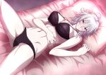  1girl absurdres ahoge bangs bare_shoulders black_bra black_panties bra breasts cleavage collarbone fate/grand_order fate_(series) highres jeanne_d&#039;arc_(alter)_(fate) jeanne_d&#039;arc_(fate) knee_up large_breasts looking_at_viewer lying miyabi_hakuro navel on_back on_bed panties pillow short_hair silver_hair solo thighs underwear yellow_eyes 