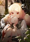  1girl absurdres arknights bangs baozi blonde_hair blurry blush commentary depth_of_field dokgo_die_docta_(d_o_t) eating eyebrows_visible_through_hair food highres holding holding_food horns ifrit_(arknights) indoors knees_up long_hair low_twintails nail_polish orange_nails oripathy_lesion_(arknights) parted_bangs red_eyes short_sleeves sitting solo twintails wide_sleeves 
