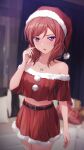  1girl bare_shoulders blurry blurry_background couch cowboy_shot crop_top cushion hand_up hat jewelry love_live! love_live!_school_idol_project medium_hair midriff navel necklace nishikino_maki purple_eyes red_hair red_skirt santa_costume santa_hat shamakho skirt solo 