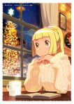 1girl alternate_costume bangs blonde_hair book border christmas christmas_tree closed_mouth commentary cup curtains eyelashes green_eyes hands_up high_ponytail highres indoors ishikawa_hideki lillie_(pokemon) long_sleeves mug night own_hands_together pokemon pokemon_(game) pokemon_sm sky smile solo star_(sky) steam sweater table white_border window wooden_wall wreath yellow_sweater 