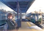  1girl bag bangs brown_eyes brown_hair daito day eyebrows_visible_through_hair gloves ground_vehicle jacket long_hair looking_at_viewer original outdoors scarf solo train train_station visible_air 