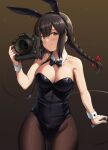  1girl animal_ears ass_visible_through_thighs black_legwear black_leotard blush braid breasts brown_eyes brown_hair camera cleavage closed_mouth cowboy_shot detached_collar eyebrows_visible_through_hair fake_animal_ears hair_between_eyes highres holding holding_camera ichikawa_feesu isonami_(kancolle) kantai_collection large_breasts leotard long_hair nikon_(company) pantyhose rabbit_ears smile solo twin_braids wrist_cuffs 