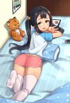  1girl ajidot andvari_(last_origin) ass bangs black_hair bow dolphin_shorts from_behind green_eyes hair_bow highres last_origin long_hair looking_at_viewer looking_back lying on_bed on_stomach open_mouth short_shorts shorts smile solo stuffed_animal stuffed_tiger stuffed_toy tablet_pc thighhighs twintails v white_legwear 