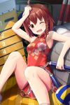  1girl absurdres ahoge alternative_girls armpits bare_arms bare_legs brown_eyes brown_hair china_dress chinese_clothes dress eyebrows_visible_through_hair gym_storeroom hand_on_own_head highres holding looking_at_viewer official_art one_eye_closed open_mouth red_dress short_hair sitting solo yuuki_miyaka 
