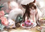  1girl ahri_(league_of_legends) animal_ears bangs barefoot breasts brown_hair cake cleavage collarbone cookie dress feet_up food fork fox_ears fox_girl fox_tail green_dress highres large_breasts league_of_legends long_hair lying on_stomach orange_eyes plate poro_(league_of_legends) shiny shiny_hair smile soles solo tail xiuluoyi00 