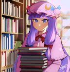  1girl artist_name bangs blue_eyes blunt_bangs blurry blurry_background book book_stack bookshelf capelet closed_mouth crescent crescent_hat_ornament dress expressionless eyebrows_visible_through_hair hat hat_ornament highres holding holding_book indoors kumaartsu long_hair long_sleeves mob_cap patchouli_knowledge pink_capelet pink_dress pink_headwear purple_hair signature solo touhou very_long_hair window 