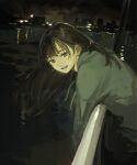  1girl bangs brown_eyes brown_hair city_lights feet_out_of_frame funabashi_(iwzry) green_hoodie highres hood hoodie leaning_forward leaning_on_rail long_hair looking_at_viewer night open_mouth original outdoors railing smile solo water 