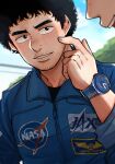  1boy afro black_hair blue_shirt character_name day facial_hair hand_up highres jaxa keroko_(keroooon) male_focus nanba_mutta nasa_logo outdoors shirt solo_focus stubble uchuu_kyoudai uniform upper_body watch 