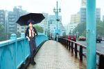  1boy belt black_footwear black_hair black_umbrella building car ground_vehicle hair_over_one_eye holding holding_umbrella jacket karushiumu_shougyo kuji_toi lamppost leaning_on_rail looking_afar male_focus motor_vehicle necktie outdoors photo_background railing rain red_necktie sarazanmai school_uniform umbrella 