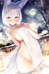  1girl animal_ear_fluff animal_ears azur_lane bangs blue_eyes blush branch breasts closed_mouth commentary_request eyebrows_visible_through_hair fox_ears highres holding holding_towel hukairi_botan icicle kaga_(azur_lane) large_breasts looking_at_viewer moon mountainous_horizon naked_towel navel night nipples nude onsen partially_submerged railing silver_hair snow solo standing steam stomach towel towel_around_breasts wet winter 