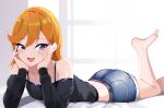  1girl :d absurdres ass bare_legs bare_shoulders barefoot black_shirt blonde_hair blue_shorts bra_strap crop_top denim denim_shorts hands_on_own_cheeks hands_on_own_face highres leg_up long_hair long_sleeves looking_at_viewer love_live! love_live!_superstar!! lying midriff mutsu_ane_daisuki off-shoulder_shirt off_shoulder on_stomach purple_eyes shibuya_kanon shirt short_shorts shorts smile solo symbol-only_commentary thighs 