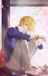  1boy anklet bangs barefoot blonde_hair blue_shirt bracelet card collarbone earrings eyebrows_visible_through_hair fate/grand_order fate_(series) full_body gilgamesh_(caster)_(fate) gilgamesh_(establishment)_(fate) gilgamesh_(fate) highres holding holding_card hugging_own_legs jacket jewelry kk7_000 looking_at_viewer male_focus necklace no_shoes official_alternate_costume red_eyes shirt short_hair sitting smile solo 