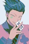  1boy blue_hair facepaint facial_mark highres hisoka_morow holding hunter_x_hunter jester looking_at_viewer male_focus playing_card_theme ryuryu_(ryuryu_09) short_hair slit_pupils smile solo spiked_hair upper_body yellow_eyes 