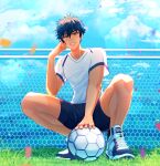  1boy absurdres ball black_shorts blurry cloud confetti depth_of_field ensemble_stars! fence grass hand_on_own_face highres lens_flare looking_at_viewer male_focus nemesis0903 net orange_eyes outdoors sazanami_jun shirt shoes shorts sky sneakers soccer soccer_ball solo squatting sweatdrop white_footwear white_shirt 