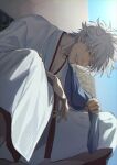  1boy blurry blurry_background brown_eyes day gintama highres hisknn japanese_clothes kimono male_focus outdoors sakata_gintoki short_hair sitting solo teeth_hold white_hair white_kimono 