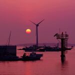  boat commentary evening harbor hoshiumisora no_humans orange_sky original outdoors purple_sky scenery shore sky sun sunset twilight water watercraft windmill 