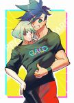  2boys androgynous black_pants black_shirt border character_name copyright_name eyebrows_visible_through_hair galo_thymos green_hair grin highres lio_fotia lukiarab male_focus multiple_boys oversized_clothes oversized_shirt pants promare purple_eyes shared_clothes shared_shirt shirt short_hair smile thumbs_up v yaoi yellow_background 